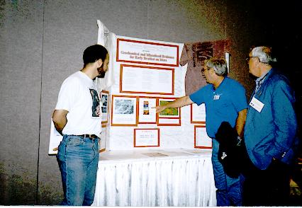 Clemmett, Gibson, and McKay looking at a poster