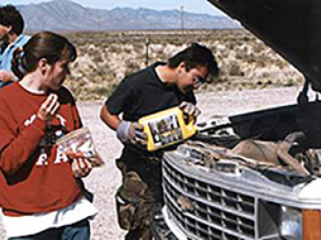 Laszlo tries all sorts of new coolants while the Zibi looks on and Will takes pictures of the ground. In the end, it was duct tape and twist-ties to the rescue--and the van was fine.