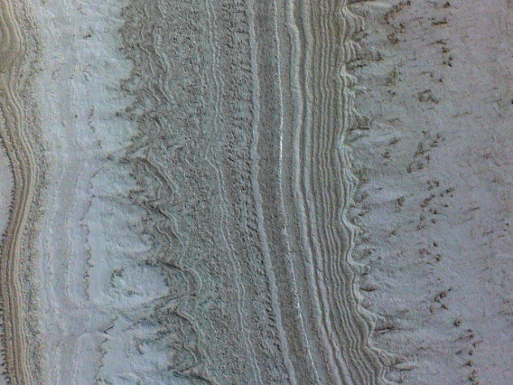 This image taken by UArizona's HiRISE camera on NASA's Mars Reconnaissance Orbiter shows ice sheets at Mars' south pole. 