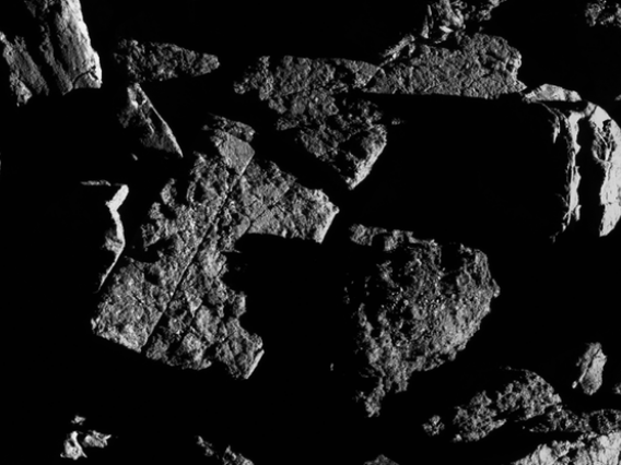 This image, taken by the spacecraft from a distance of 0.4 miles, shows a group of large boulders located just north of asteroid Bennu’s equatorial region, with two exhibiting linear cracks. For scale, the crack that runs through the rectangular boulder (