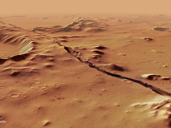 A view of the Cerberus Fossae system on Mars, showing fractures cutting through hills and craters.