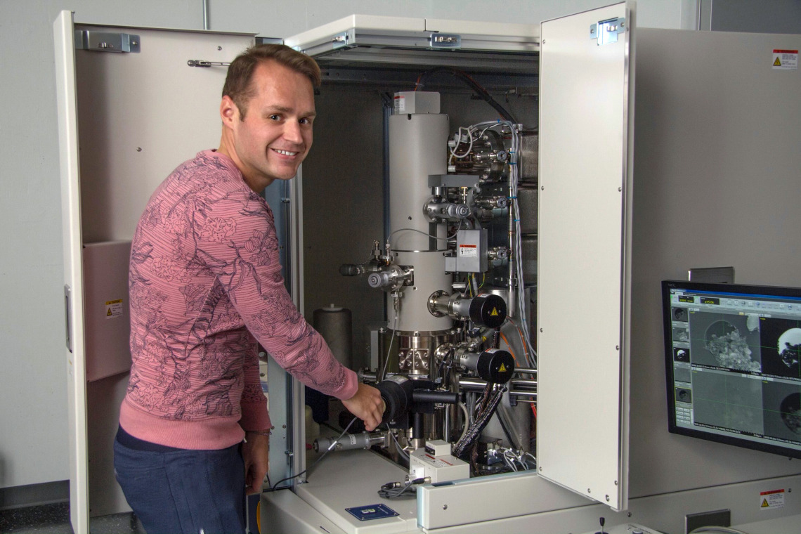 Pierre Haenecour, the study's lead author, is pictured with one of the ultra-high-resolution electron microscopes used to obtain chemical and microstructural information about the stardust grain. (Photo: Maria Schuchardt/University of Arizona)