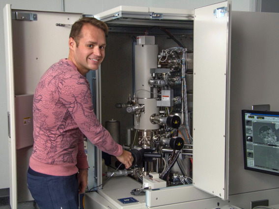 Pierre Haenecour, the study's lead author, is pictured with one of the ultra-high-resolution electron microscopes used to obtain chemical and microstructural information about the stardust grain. (Photo: Maria Schuchardt/University of Arizona)
