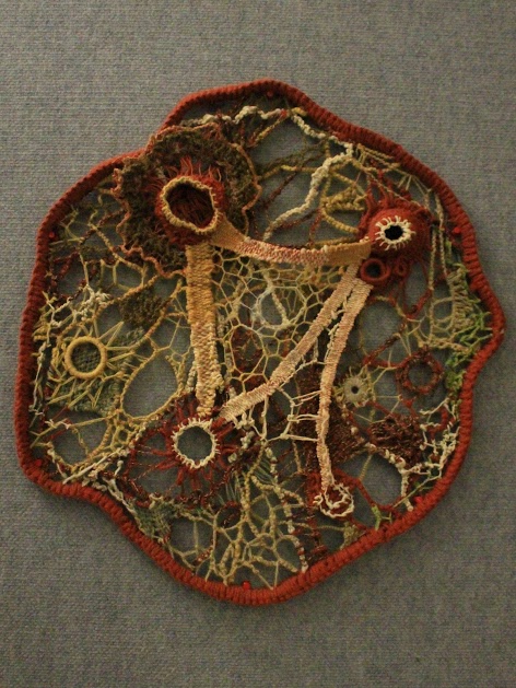 Second Place, Fine Art Category, a circular fiber sculpture with many interweaving connections