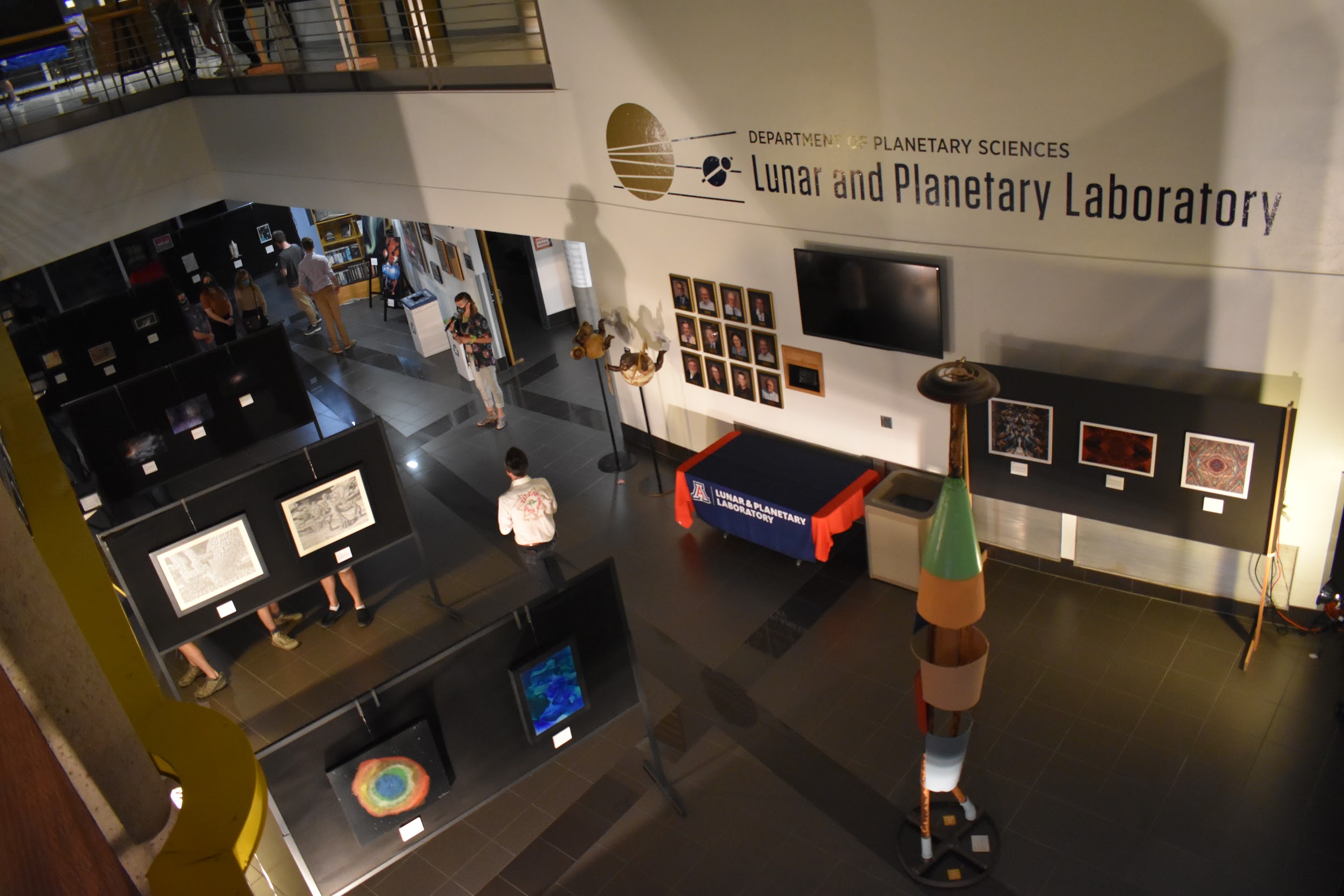 A view from high above several art pieces with the Lunar and Planetary Lab logo featured