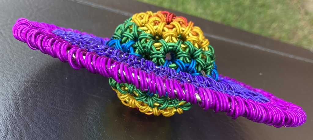 Sculpture of the planet Saturn made with rainbow colored rings.	