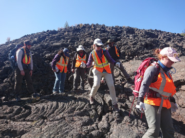 Students clamber across a cooled lava flow
