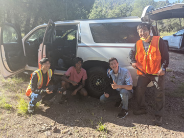Students sit by the vans after a long day of hiking. Image by Robert Melikyan