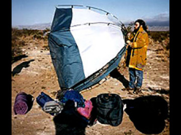 Andy flies his tent in winds that knocked down the wall of a mall in El Paso.