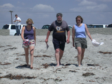 Ingrid and Jani channel Baywatch as they escort Jay onto the beach.