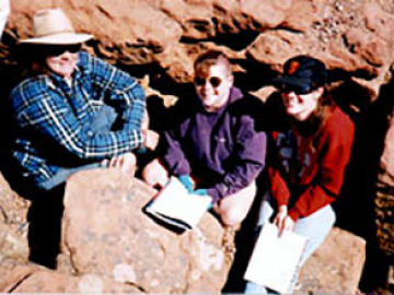 Cynthia, Barb, and Zibi try to keep warm in a rock crevice while learning about the mechanics of Plateau uplift.