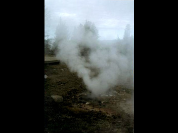 Our first sight of an erupting geyser, where superheated water and steam escape forcefully from a narrow crack in the ground.