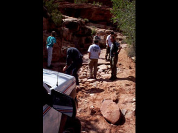 Here you see the first vehicle encountering the beginning of the Elephant Hill climb. It may not look like it but there is a two or three foot elevation difference between the surface that the Suburban is on and the one that the figures in the background are on. We had to make a makeshift ramp out of large cobbles to get the vehicles up this one.