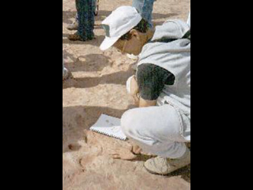 Zibi Turtle and Jeff Johnson compare their hands with those of the dinosaurs.