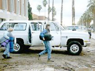 Jen and Kim pack up the vans.