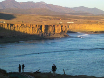 Day 4. Our spectacular campsite at Punta San Jose. Caravan is seen in the distance as we hike down to the beach to look for ammonites ... 