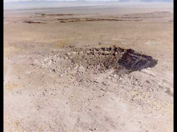 This was as close as we got to Schooner, 35 kilotons detonated 108m underground. The crater is 260m across and 63m deep, approximately 1/4 the size of Meteor Crater and similar in morphology. Below is the glossy 8x10 of Schooner provided by the NTS PR office.