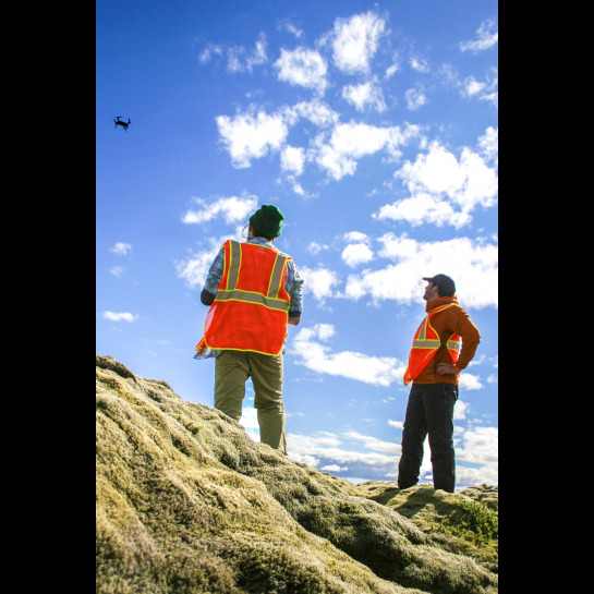 Corbin Kling controls a UAV in mid flight as Dr. Christopher Hamilton oversees. 