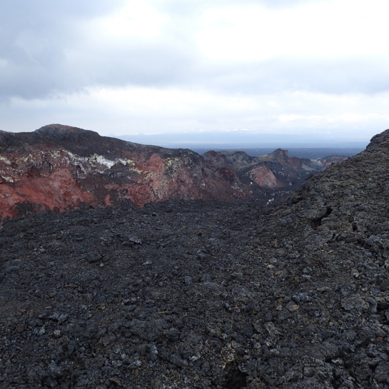 Hiking in and out of the vent region ("scamperhraun") was a difficult task for the LiDAR survey team. Scientists can be seen in the distance exploring a side channel that branches off to the left. 