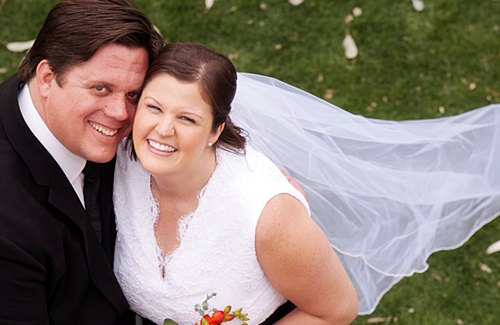 Jade Bond and Jason Carter pose in wedding outfits.