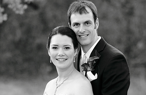 Lissa Ong and Galen Holt pose in wedding outfits.