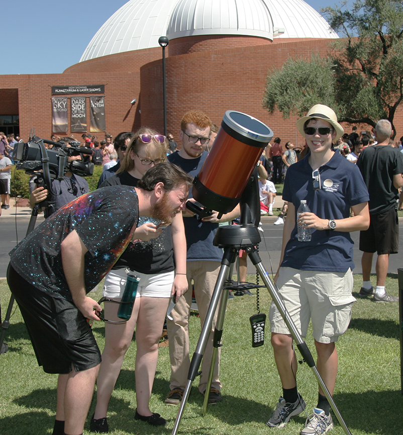 Photo of eclipse watchers with telescope