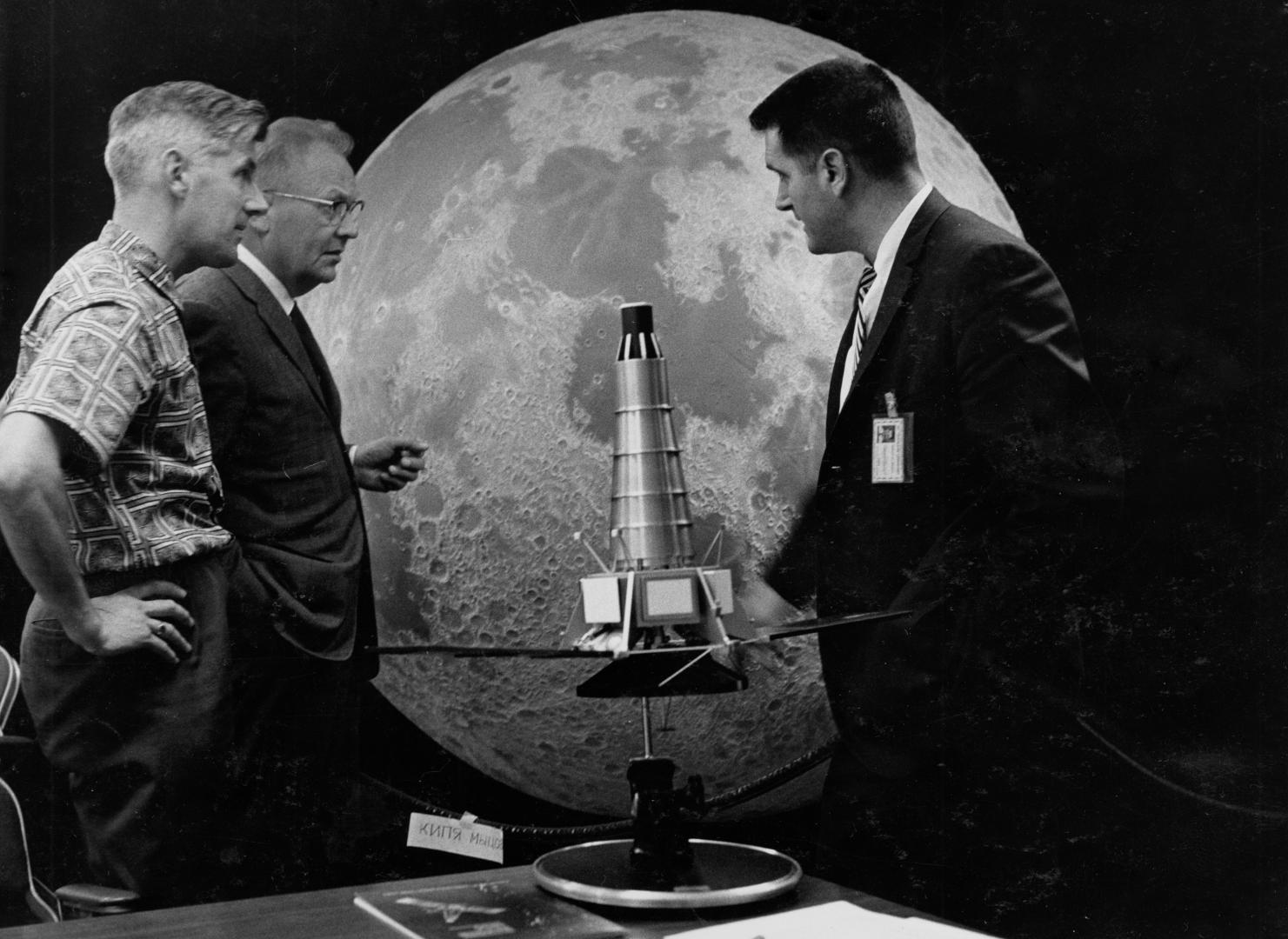 Scientists Ewen Whitaker, Gerard Kuiper and Ray Heacock in front of a Ranger model and lunar hemisphere which is now located at Flandrau Science Center and Planetarium. / UArizona Lunar and Planetary Lab photo.