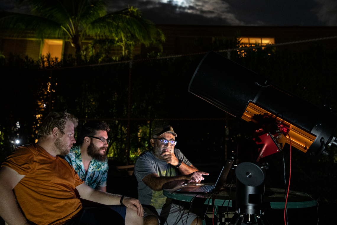 UArizona Space4 Center lab manager Neil Pearson, aerospace and mechanical engineering graduate student Tanner Campbell and Vishnu Reddy, professor at the UArizona Lunar and Planetary Laboratory and director of the Space4 Center, observe the separation of the OSIRIS-REx sample return capsule from the spacecraft from Kihei, Hawaii, on Sept. 24.