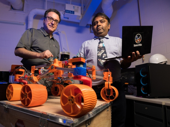 UArizona engineering faculty members Jekan Thanga (right) and Moe Momayez with a low-cost, rapidly designed, 3D-printed rover prototype used for testing a new generation of miniature sensors for applications in lunar mining.
