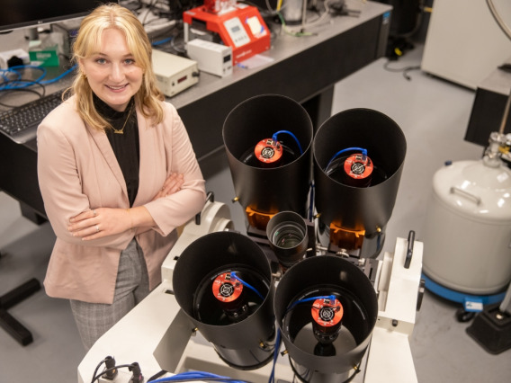 Grace Halferty, a senior graduating this summer with a bachelor's degree in aerospace and mechanical engineering and the paper's lead author, with the instrument researchers built to measure the brightness and position of SpaceX Starlink satellites.Kyle 