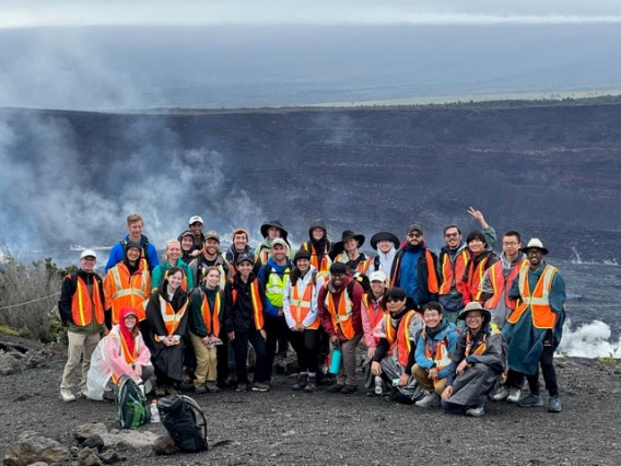 Students gathered in front of steaming lava.
