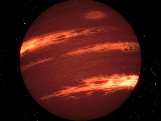 This artist's concept shows a brown dwarf with bands of clouds, thought to resemble those seen on Neptune and the other outer planets in the solar system. By using NASA's Spitzer Space Telescope, astronomers have found that the varying glow of brown dwarfs over time can be explained by bands of patchy clouds rotating at different speeds. (Animation: NASA/JPL-Caltech)