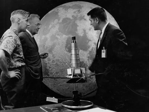 Scientists Ewen Whitaker, Gerard Kuiper and Ray Heacock in front of a Ranger model and lunar hemisphere which is now located at Flandrau Science Center and Planetarium. / UArizona Lunar and Planetary Lab photo.