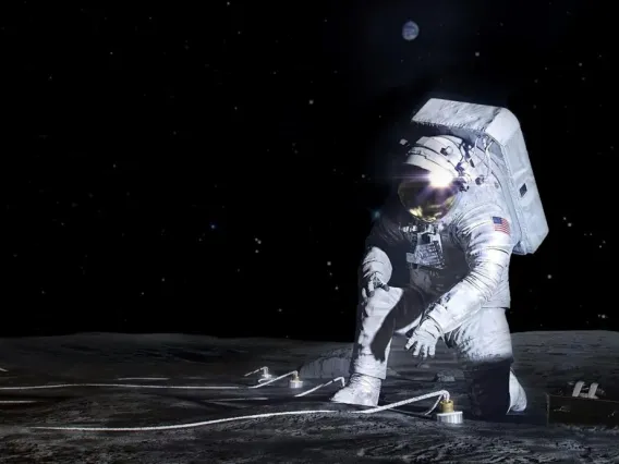 Artemis astronaut deploying an instrument on the lunar surface
