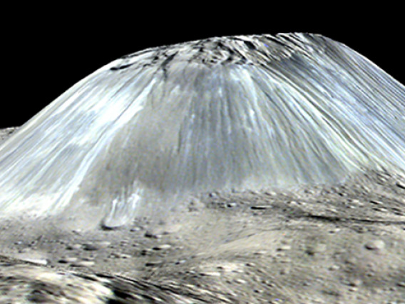 Ceres' lonely mountain, Ahuna Mons, is seen in this simulated perspective view. The elevation has been exaggerated by a factor of two. The view was made using enhanced-color images from NASA's Dawn mission. (Image: NASA)