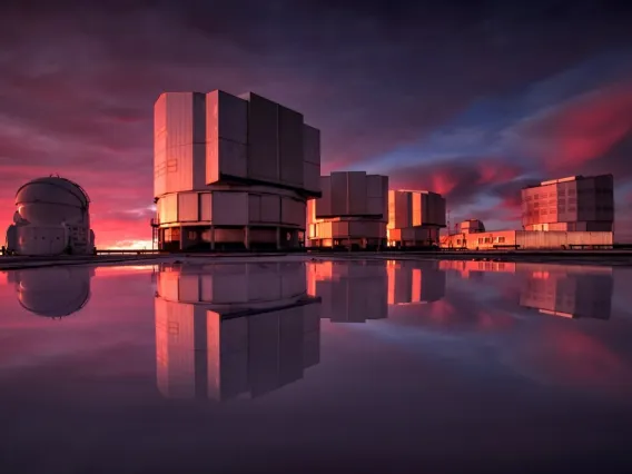 The Very Large Telescope, or VLT, at the Paranal Observatory in Chile's Atacama Desert. VLT's instrumentation was adapted to conduct a search for planets in the Alpha Centauri system as part of the Breakthrough initiatives. This image of the VLT is painted with the colors of the sunset reflected in water on the platform. A. Ghizzi Panizza/ESO