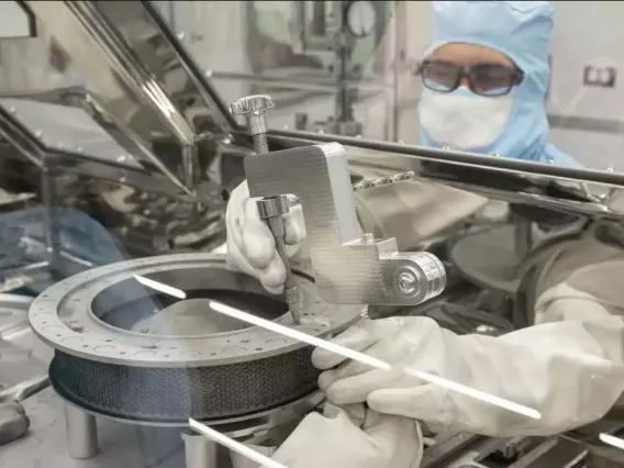OSIRIS-REx curation team attempting to remove the two remaining fasteners