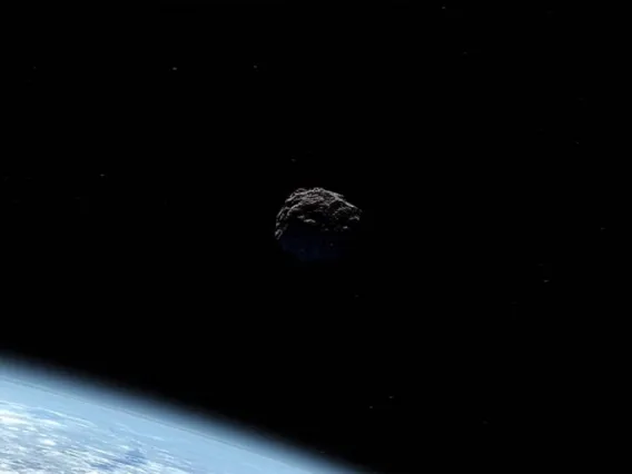 Artist's concept of an asteroid passing Earth.