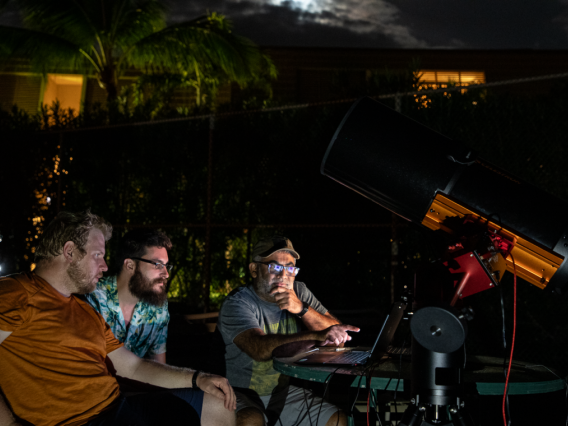 UArizona Space4 Center lab manager Neil Pearson, aerospace and mechanical engineering graduate student Tanner Campbell and Vishnu Reddy, professor at the UArizona Lunar and Planetary Laboratory and director of the Space4 Center, observe the separation of the OSIRIS-REx sample return capsule from the spacecraft from Kihei, Hawaii, on Sept. 24.