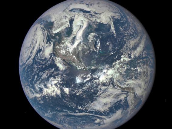 NASA image of the Earth. Mexico is at the center, with other portions of North and South America peaking out from the swirling clouds that cover much of the globe.